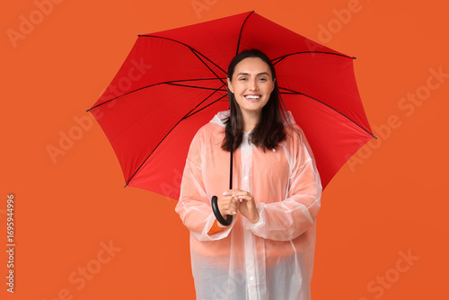 Happy young woman in rainco...
