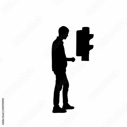 Pedestrian waiting at a crosswalk for a green traffic light signal