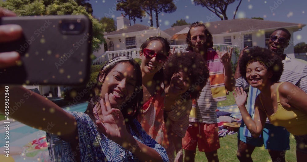 Obraz premium Group of six friends taking selfie on lawn beside backyard pool, with smartphone and umbrella