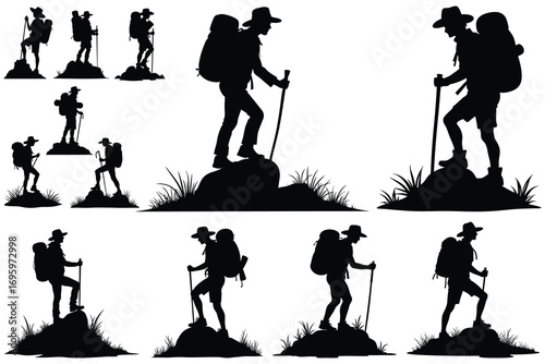Silhouette of hikers with backpacks and walking sticks on rocks