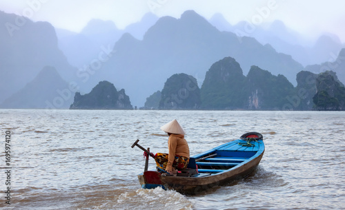 Obraz na płótnie Sunset In The Morning On The harbour In Ha long Bay with fisboat - Vietnam