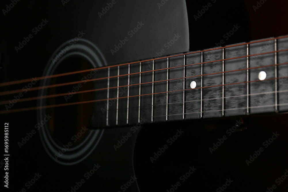 Fototapeta premium Modern guitar on dark background, closeup