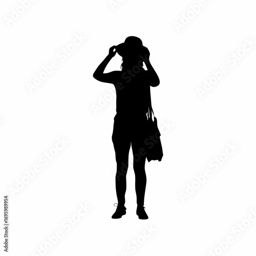 Silhouette of a shopper trying on a hat at a market stall