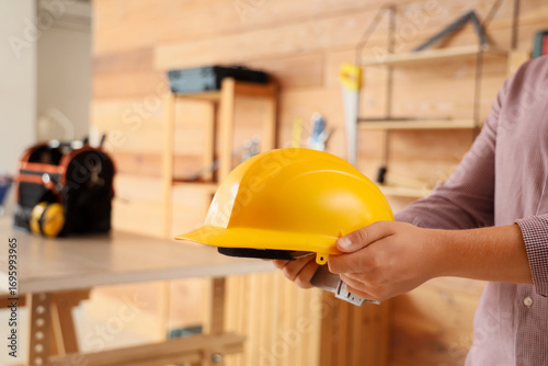 Man holding hardhat in work...