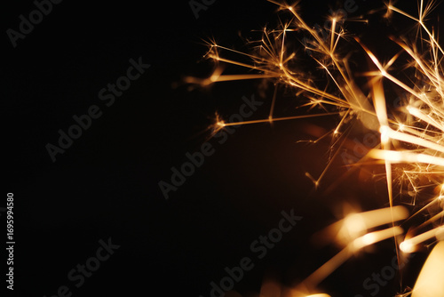 Close up of burning sparklers on black background
