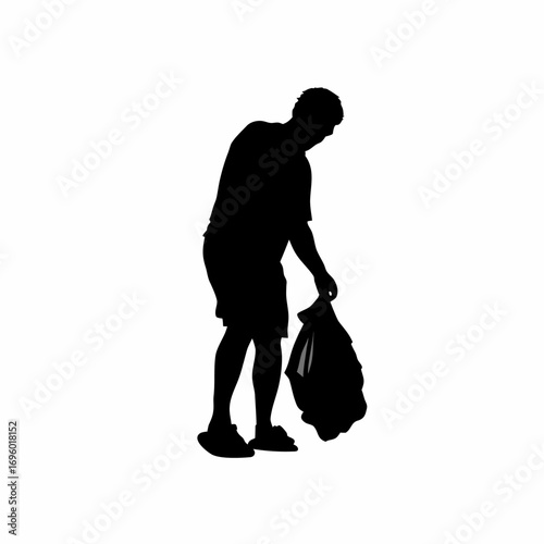Silhouette of person collecting plastic waste from riverbank for environmental cleanup