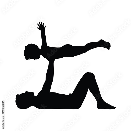 Father lifts child in playful acrobatic pose silhouette