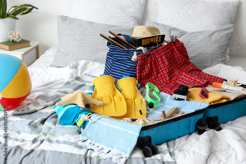 Open suitcase with men's sw...