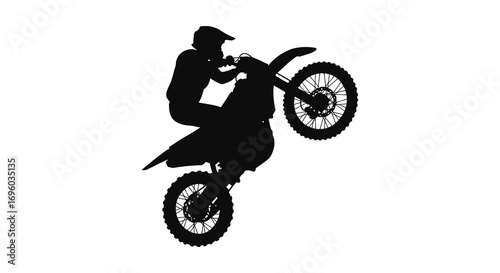 a daring motorcyclist performing an impressive wheelie stunt outdoors