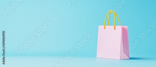 Pink Shopping Bag With Yellow Handles Against a Bright Blue Background
