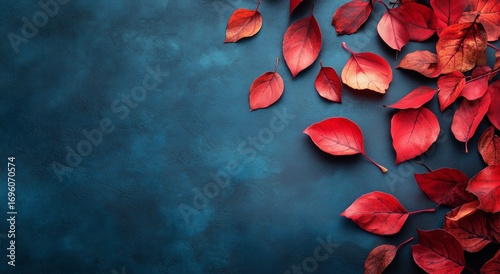 Vibrant Red Leaves Spread Across a Blue Background Capturing Autumns Beauty i...