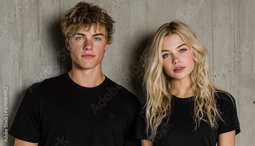 Couple Poses Against a Textured Wall in Casual Black Shirts During a Bright I...