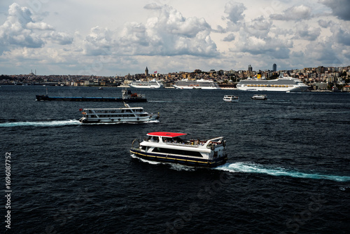 Costa Fortuna cruise ship and other little big ships on the Bosphorus of Istanbul. Ferries and passenger boats are visible cruising the Bosphorus, with large cruise ships in the background. Galata Tow