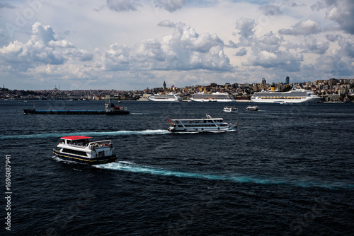 Costa Fortuna cruise ship and other little big ships on the Bosphorus of Istanbul. Ferries and passenger boats are visible cruising the Bosphorus, with large cruise ships in the background. Galata Tow