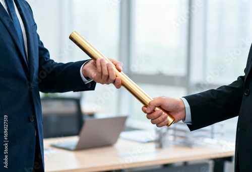 Business succession, leadership transition and teamwork concept with employees passing golden baton in modern office for collaboration, responsibility and management handover