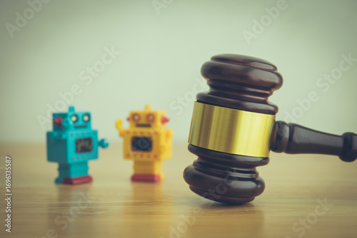 Hammer judge gavel and AI artificial intelligence bots on wooden table with white wall background copy space. Artificial intelligence AI governance, law, regulation, act concept.