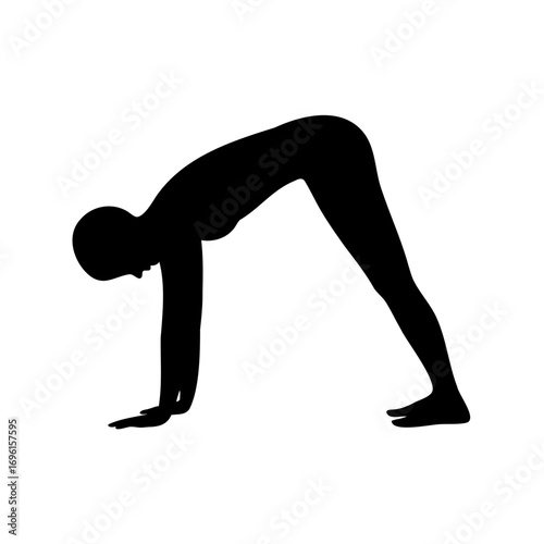 Silhouette of person performing downward dog yoga pose, focused health concept