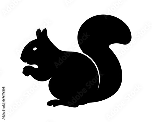 Silhouette of a charming squirrel holding food with its bushy tail