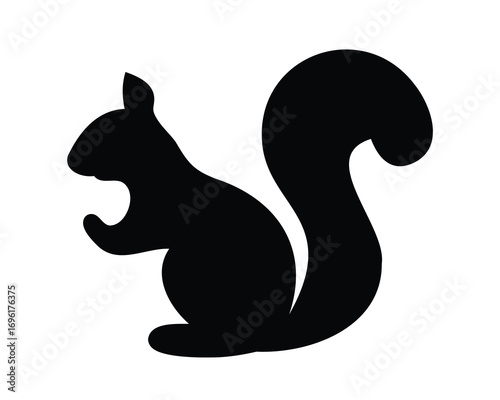 Silhouette of a squirrel in a standing position with fluffy tail
