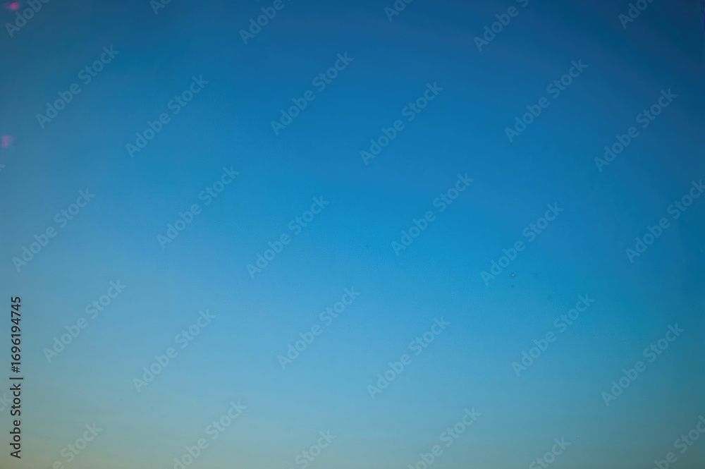 Obraz premium Bright blue sky without clouds, perfect for wallpaper and backgrounds, showcasing clear weather and a pleasant evening.