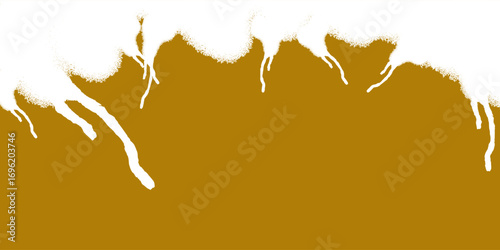 Thick white creamy foam overflowing and dripping down a golden amber liquid surface.