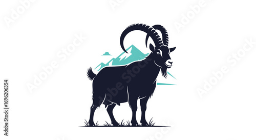 Majestic alpine ibex standing proudly on a grassy knoll with snow capped mountains behind it a symbol of wilderness and resilience in nature