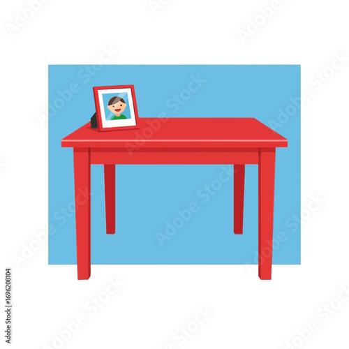 Red table with a framed picture on top against a light blue background.