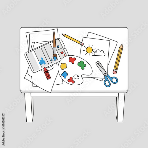 Art supplies on white table including paints crayons scissors and paper drawings.