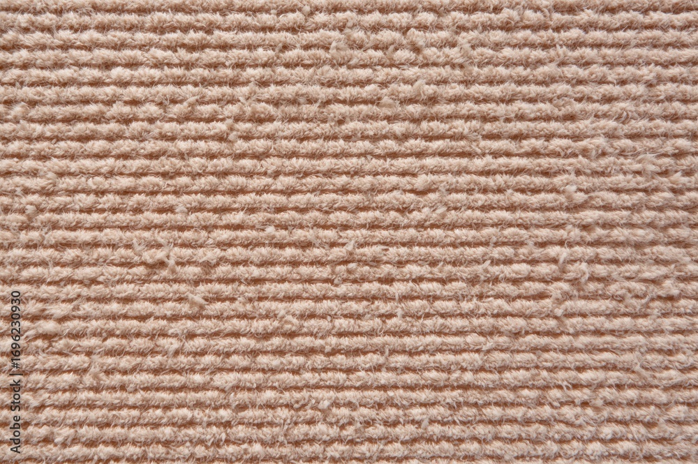 Fototapeta premium Detailed shot of a woven fabric featuring horizontal patterns in earthy hues, ideal for cozy home or apparel designs