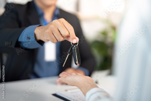 Billede på lærred Key Handover. Insurance agent handing over car keys to client.