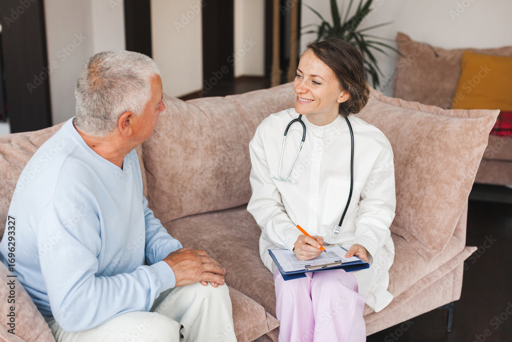 Obraz premium Female professional doctor showing medical test result explaining prescription using clipboard visiting senior elderly old man patient at home sitting on sofa