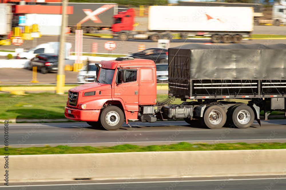 Fototapeta premium Heavy Duty Journey: Red Power on the Road