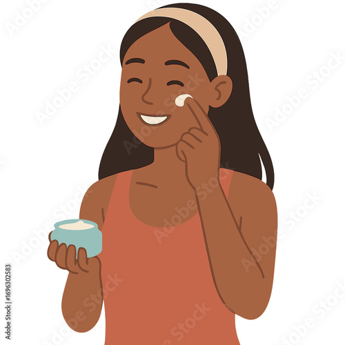 A woman smiles while applying a face cream to her skin