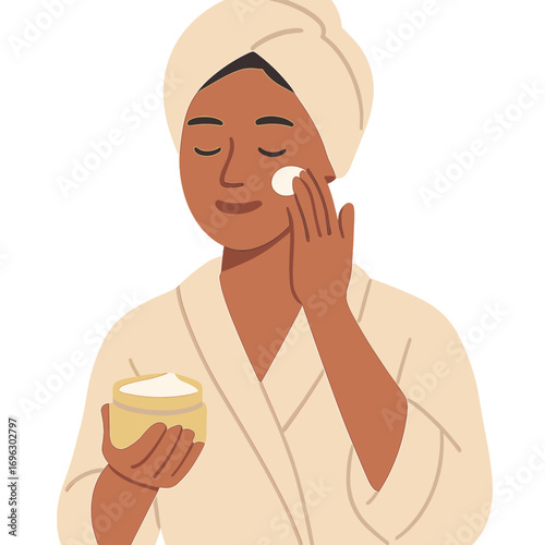 A woman applies moisturizer to her face as part of her morning routine