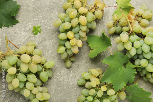 Fresh green grape on grey concrete background.