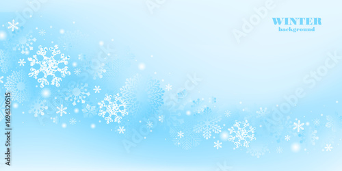 Winter snowy background. Snowflakes, blue sky.  Christmas, New Year nature landscape. Snowfall. Holiday mood.