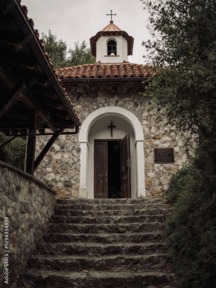 Fototapeta premium Historic stone chapel entrance serene forest photography calm environment close-up view spiritual essence