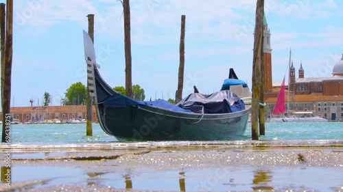 The tourist area of Venice with boats on the water and the architecture of the old city.