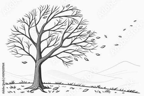 Bare tree losing leaves in the wind on a hillside