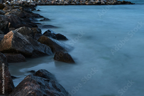 Waves of the baltic sea at the beach, long exposure, stones