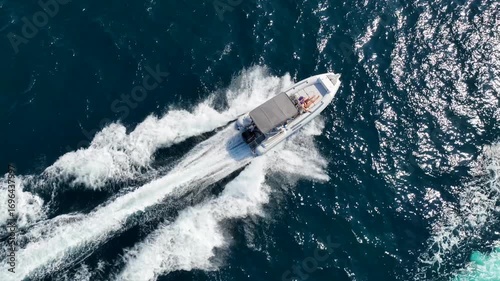 Wallpaper Mural Aerial drone tracking cinematic video of inflatable rib speed boat cruising in high speed in mediterranean deep blue sea bay Torontodigital.ca