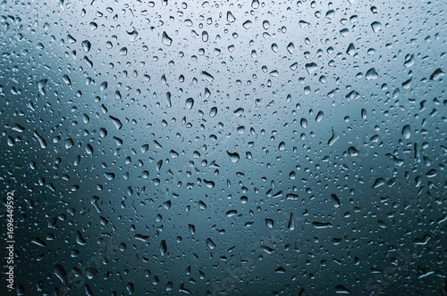 Condensation droplets on a misty, damp window surface