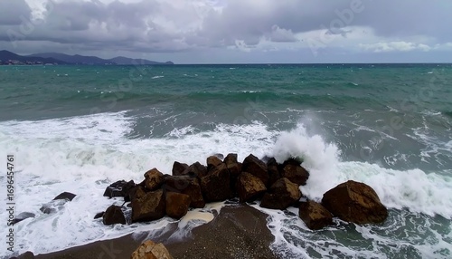 Stormy sea, waves crashing over rocks on a beach