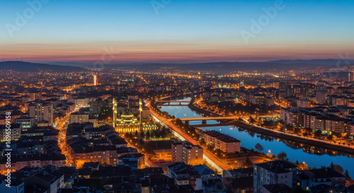 Captivating Aerial View of a Cityscape at Twilight With Illuminated Buildings and Reflecting Waterways