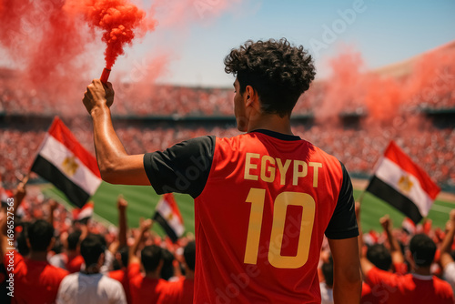 Egyptian soccer fan with red smoke flare in stadium