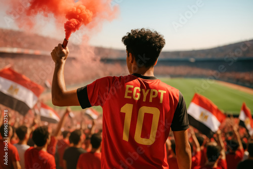 Egyptian soccer fan with red smoke flare in stadium