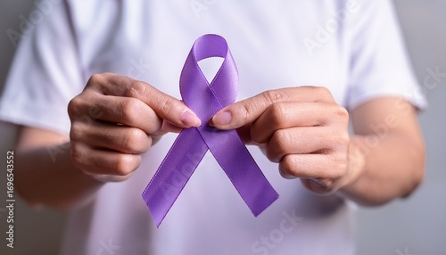 hand holding purple awareness ribbon pancreatic cancer alzheimer disease epilepsy