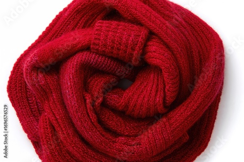 Handmade heart-shaped knitted scarf on plain white backdrop