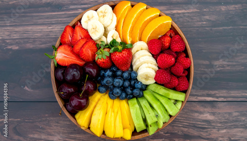Colorful fruit platter arrangement, showcasing sliced fruits in a circular pattern.