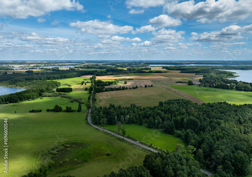 A road between hills and lakes, near the settlement of Likszany, Iława Lake District, Poland